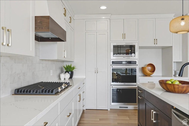 954 S Sandy Ln, Spanish Fork, UT 84660 - kitchen with appliances with stainless steel finishes, wall chimney range hood, white cabinetry, light wood-style flooring, and recessed lighting