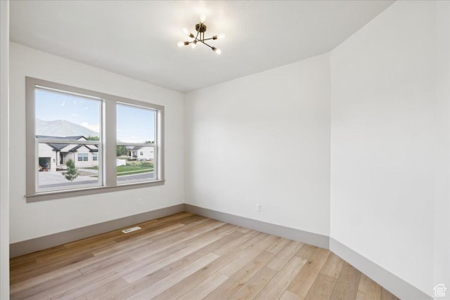 954 S Sandy Ln, Spanish Fork, UT 84660 - empty room featuring a chandelier and light wood-type flooring