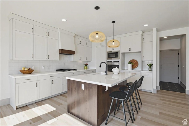 954 S Sandy Ln, Spanish Fork, UT 84660 - kitchen featuring appliances with stainless steel finishes, light wood finished floors, white cabinetry, tasteful backsplash, and recessed lighting