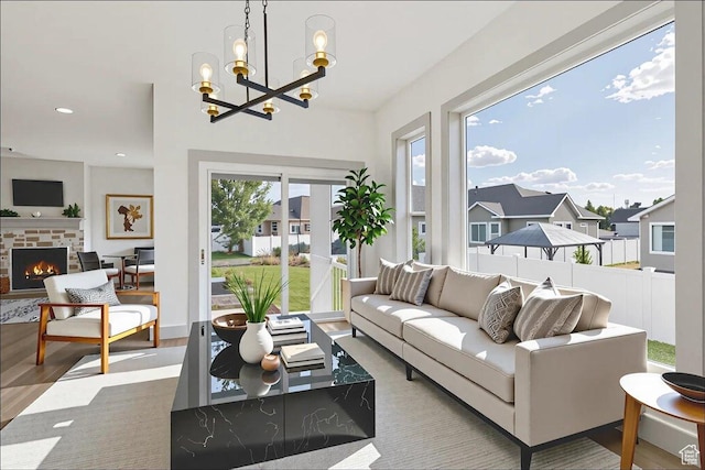 954 S Sandy Ln, Spanish Fork, UT 84660 - living area featuring a chandelier, a warm lit fireplace, recessed lighting, and wood finished floors