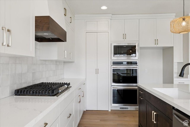 954 S Sandy Ln, Spanish Fork, UT 84660 - kitchen with stainless steel appliances, custom range hood, white cabinetry, and recessed lighting