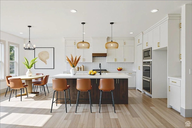 954 S Sandy Ln, Spanish Fork, UT 84660 - kitchen featuring appliances with stainless steel finishes, light countertops, white cabinetry, light wood-type flooring, and recessed lighting