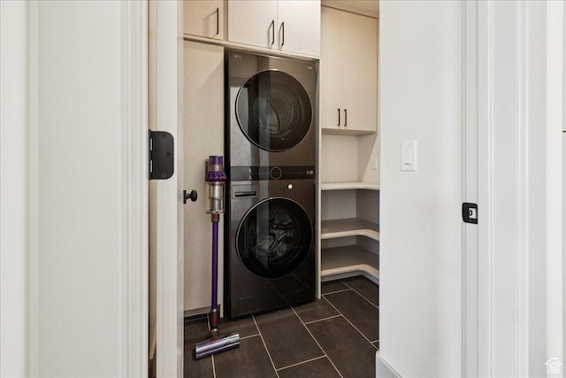954 S Sandy Ln, Spanish Fork, UT 84660 - laundry area featuring stacked washer / dryer, cabinet space, and dark tile patterned flooring