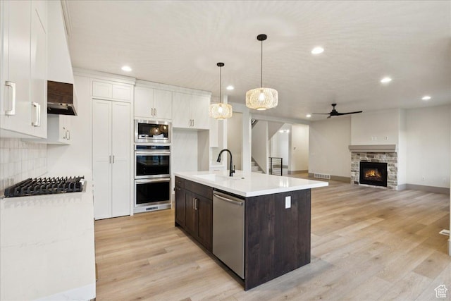 954 S Sandy Ln, Spanish Fork, UT 84660 - kitchen with appliances with stainless steel finishes, a ceiling fan, white cabinetry, light countertops, and dark brown cabinetry