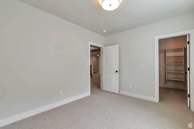 551 W Summerhill Ln, Centerville, UT 84014 - unfurnished bedroom featuring light carpet, a walk in closet, and a closet