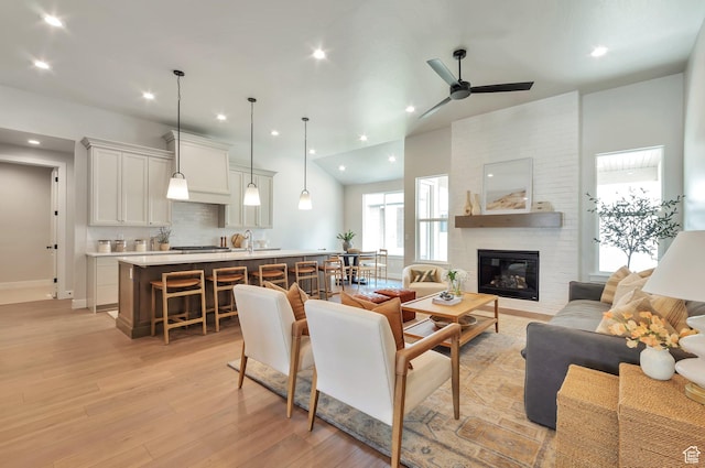 551 W Summerhill Ln, Centerville, UT 84014 - living room featuring light wood-type flooring, a fireplace, a ceiling fan, and recessed lighting