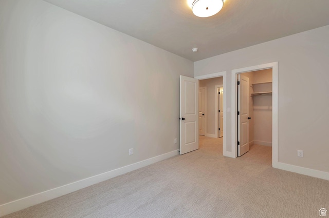 551 W Summerhill Ln, Centerville, UT 84014 - unfurnished bedroom featuring light colored carpet, a walk in closet, and a closet