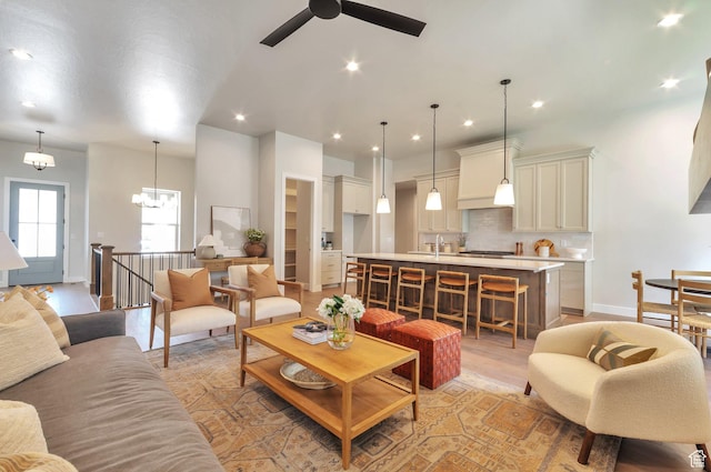 551 W Summerhill Ln, Centerville, UT 84014 - living area featuring a ceiling fan, recessed lighting, light wood finished floors, and a chandelier