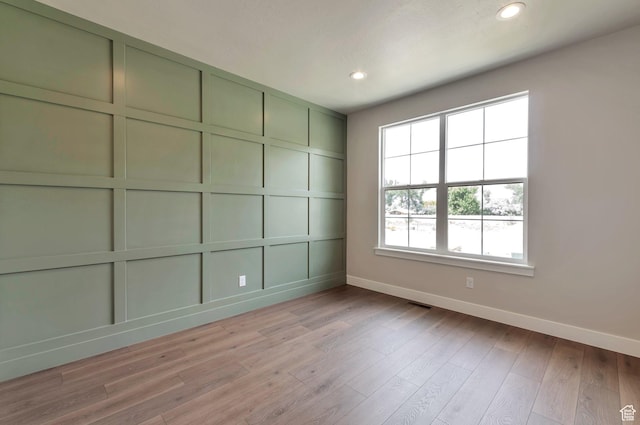 551 W Summerhill Ln, Centerville, UT 84014 - empty room with healthy amount of natural light, recessed lighting, light wood finished floors, and a decorative wall