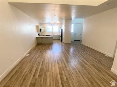 3985 W 1960 N, Lehi, UT 84043 - unfurnished living room featuring dark wood finished floors and a chandelier