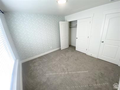 3985 W 1960 N, Lehi, UT 84043 - unfurnished bedroom featuring carpet floors, wallpapered walls, and a closet