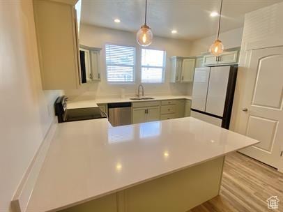 3985 W 1960 N, Lehi, UT 84043 - kitchen with freestanding refrigerator, stove, a peninsula, dishwasher, and light countertops