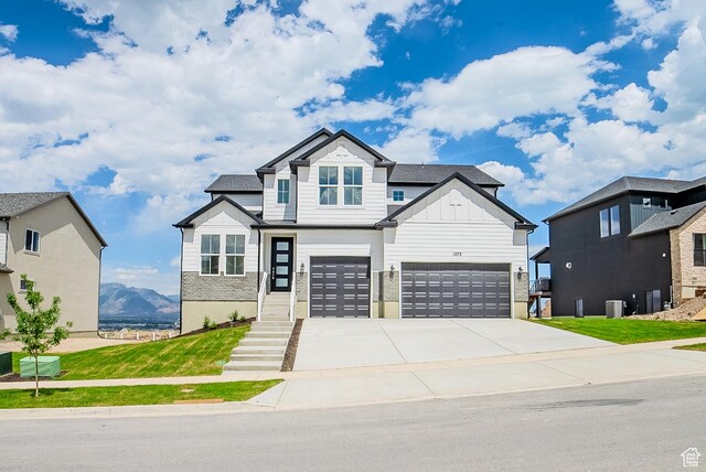 1272 S Boxelder Dr, Saratoga Springs, UT 84005 - view of front of home with an attached garage, board and batten siding, and driveway