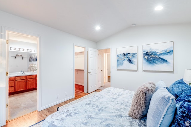 1282 W 1200 S, Woods Cross, UT 84087 - bedroom featuring light wood finished floors, vaulted ceiling, a walk in closet, ensuite bath, and recessed lighting