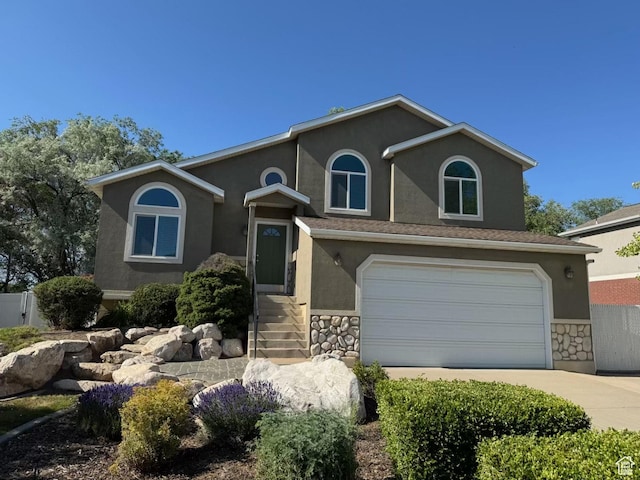 1282 W 1200 S, Woods Cross, UT 84087 - view of front of property with stucco siding, stone siding, driveway, and a garage