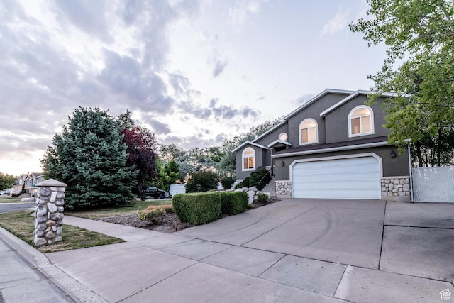 1282 W 1200 S, Woods Cross, UT 84087 - view of front of home with concrete driveway, stucco siding, stone siding, and a garage