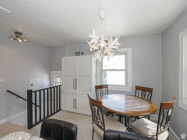 1527 E Princeton Ave S, Salt Lake City, UT 84105 - dining area with a chandelier, light tile patterned floors, and a textured ceiling