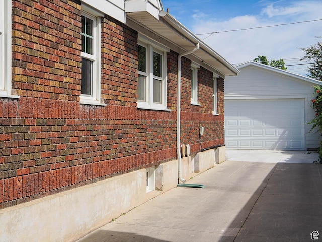 1527 E Princeton Ave S, Salt Lake City, UT 84105 - view of home's exterior featuring brick siding, concrete driveway, and an outbuilding