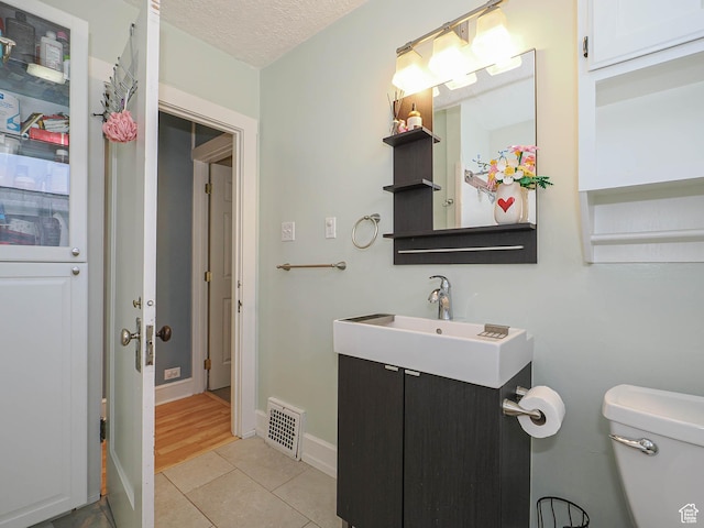 1527 E Princeton Ave S, Salt Lake City, UT 84105 - half bath featuring vanity, tile patterned floors, and a textured ceiling
