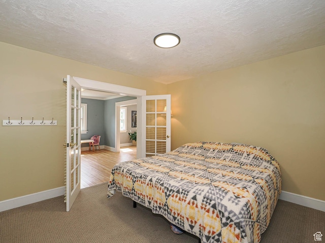 1527 E Princeton Ave S, Salt Lake City, UT 84105 - carpeted bedroom featuring french doors and a textured ceiling
