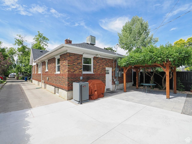 1527 E Princeton Ave S, Salt Lake City, UT 84105 - view of side of home featuring a patio, brick siding, a chimney, and roof with shingles
