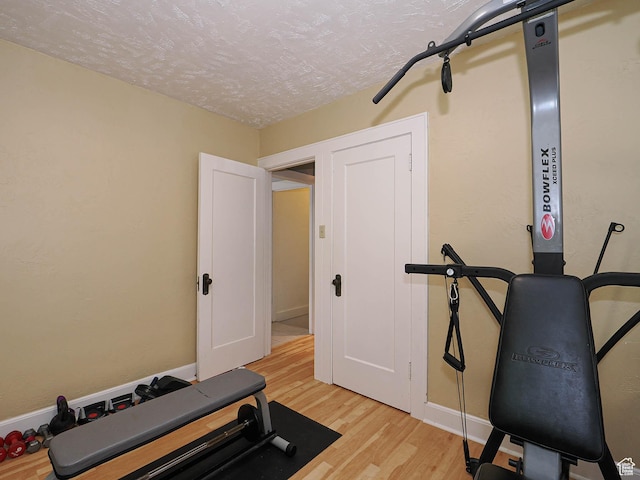 1527 E Princeton Ave S, Salt Lake City, UT 84105 - exercise room with light wood-style flooring and a textured ceiling