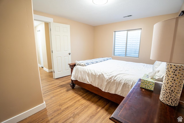 6561 S Evening Glow Ct W, West Jordan, UT 84081 - bedroom featuring baseboards and light wood-style floors