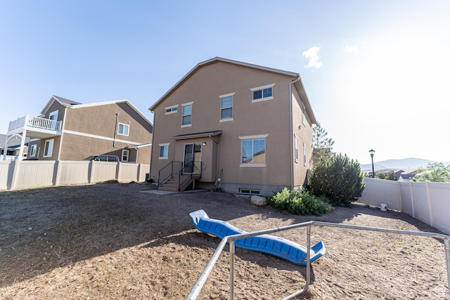 6561 S Evening Glow Ct W, West Jordan, UT 84081 - rear view of property with a fenced backyard and stucco siding
