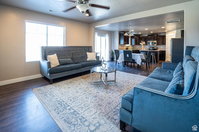 6561 S Evening Glow Ct W, West Jordan, UT 84081 - living area featuring a chandelier, a ceiling fan, dark wood-style floors, and a textured ceiling
