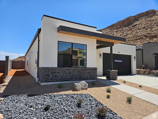 1465 S Staircase Way Unit 4065, Washington, UT 84780 - modern home featuring stone siding, driveway, stucco siding, an attached garage, and a mountain view
