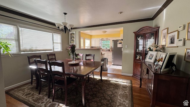 1924 E 2100 S, Salt Lake City, UT 84106 - dining space featuring a chandelier, wood finished floors, and crown molding