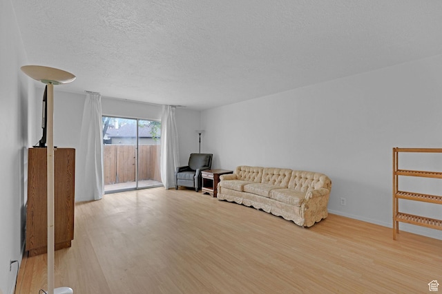 597 W Brookshire Dr, Ogden, UT 84405 - living area featuring wood finished floors and a textured ceiling