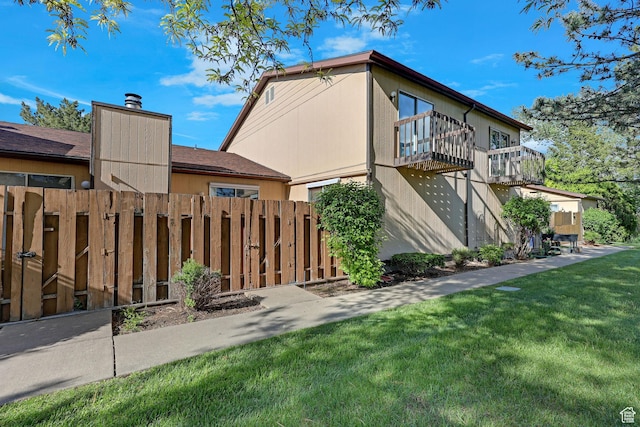 597 W Brookshire Dr, Ogden, UT 84405 - rear view of property with a balcony and a chimney
