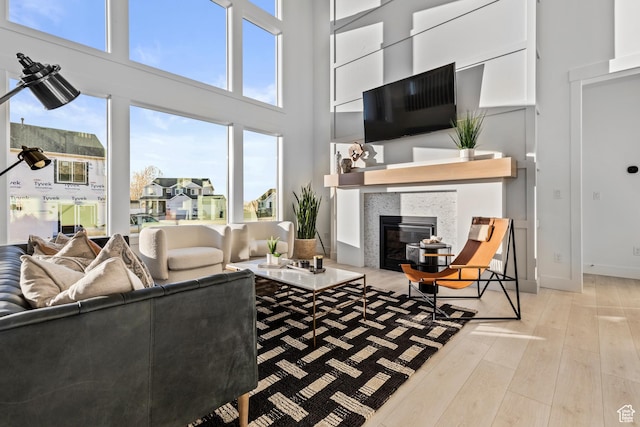 168 N 870 E Unit 22, Tremonton, UT 84337 - living room featuring a fireplace, wood finished floors, and a towering ceiling