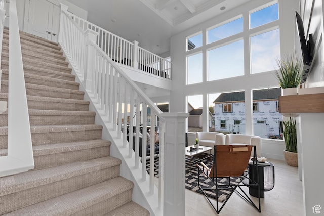 168 N 870 E Unit 22, Tremonton, UT 84337 - staircase featuring wood finished floors, a towering ceiling, beamed ceiling, coffered ceiling, and recessed lighting