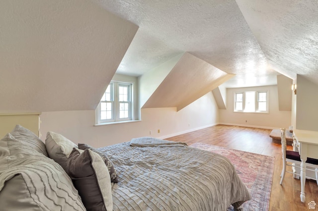 648 E 2550 N, North Ogden, UT 84414 - bedroom featuring a textured ceiling, vaulted ceiling, and wood finished floors