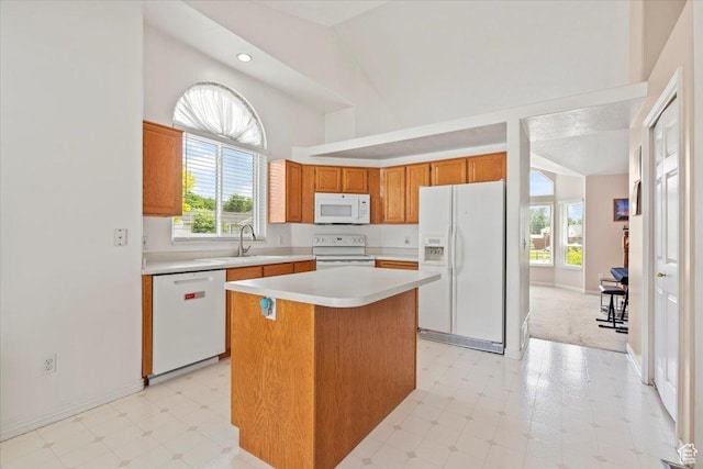 1014 W 4150 S, Riverdale, UT 84405 - kitchen with white appliances, a center island, light countertops, brown cabinetry, and high vaulted ceiling