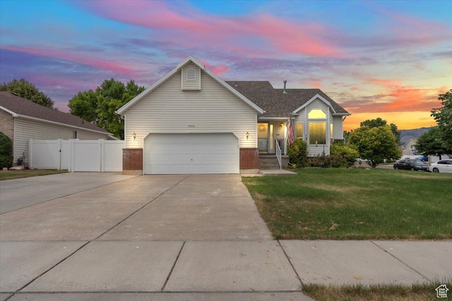 1014 W 4150 S, Riverdale, UT 84405 - traditional-style house with concrete driveway, brick siding, and a gate