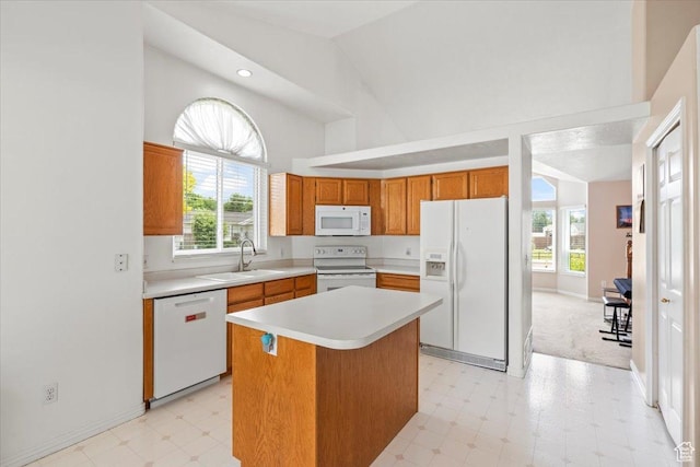 1014 W 4150 S, Riverdale, UT 84405 - kitchen featuring white appliances, light floors, light countertops, brown cabinetry, and high vaulted ceiling