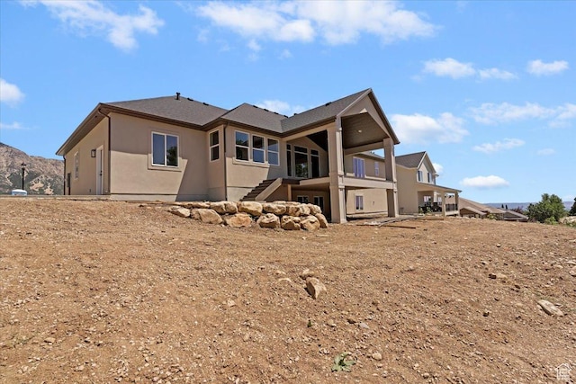 4095 N 100 E, North Ogden, UT 84414 - back of property featuring stucco siding, stairway, and a balcony