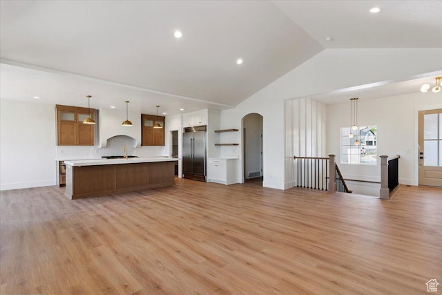 4095 N 100 E, North Ogden, UT 84414 - kitchen with stainless steel built in refrigerator, light countertops, arched walkways, vaulted ceiling, and a spacious island