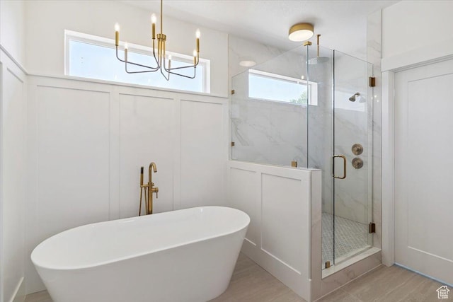 4095 N 100 E, North Ogden, UT 84414 - full bathroom featuring a decorative wall, a marble finish shower, a freestanding tub, and a chandelier