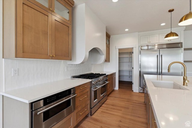 4095 N 100 E, North Ogden, UT 84414 - kitchen featuring high end appliances, decorative backsplash, light wood finished floors, light countertops, and glass insert cabinets