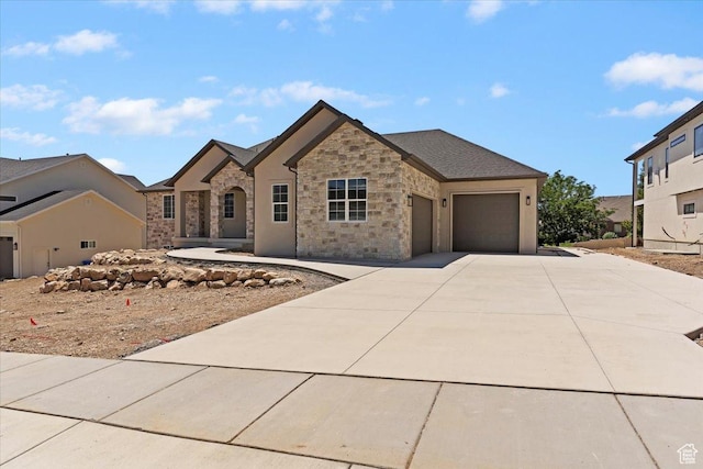 4095 N 100 E, North Ogden, UT 84414 - view of front of house featuring concrete driveway, an attached garage, and stone siding