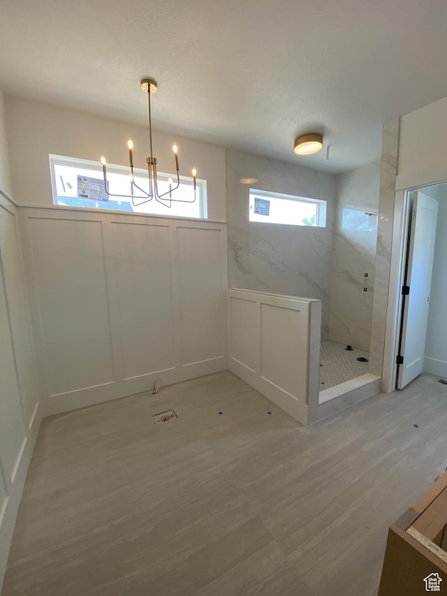 4095 N 100 E, North Ogden, UT 84414 - interior space featuring a chandelier, a decorative wall, light wood-style flooring, and wainscoting