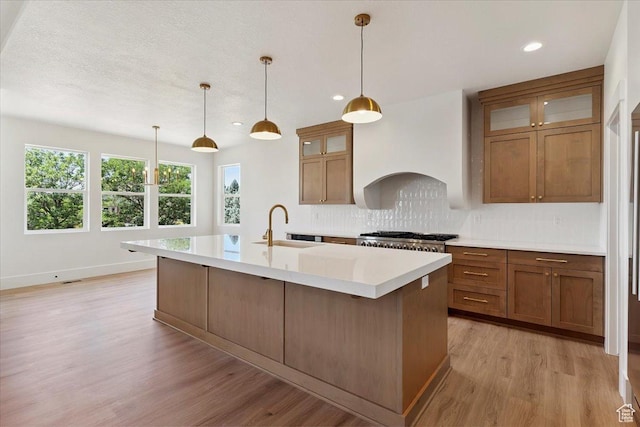 4095 N 100 E, North Ogden, UT 84414 - kitchen featuring tasteful backsplash, brown cabinetry, light wood-style flooring, light countertops, and recessed lighting