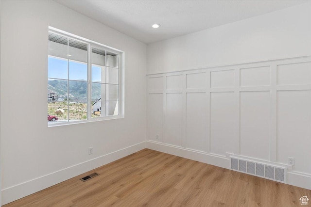 4095 N 100 E, North Ogden, UT 84414 - spare room with light wood-style floors, a decorative wall, and recessed lighting