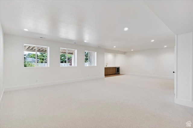 4095 N 100 E, North Ogden, UT 84414 - unfurnished living room featuring light colored carpet, wet bar, and recessed lighting