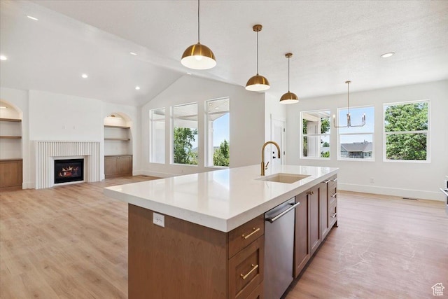 4095 N 100 E, North Ogden, UT 84414 - kitchen featuring dishwasher, light wood finished floors, light countertops, an island with sink, and decorative light fixtures