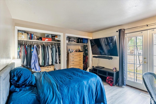 1454 Lancelot Dr, Provo, UT 84601 - bedroom featuring wood finished floors, access to outside, and multiple closets